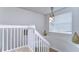 Circular staircase landing with window and unique lighting at 20131 Nob Oak Ave, Tampa, FL 33647