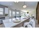 Modern kitchen with white cabinets, marble countertops, island, and backyard view at 20131 Nob Oak Ave, Tampa, FL 33647