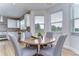 Bright dining area with a round wooden table and four gray chairs at 20131 Nob Oak Ave, Tampa, FL 33647