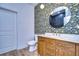Modern bathroom with patterned wallpaper and wood vanity at 20131 Nob Oak Ave, Tampa, FL 33647