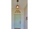 Charming light green front door with arched window at 812 Mccallister Ave, Sun City Center, FL 33573