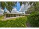 Landscaped backyard with spacious lawn and screened patio at 812 Mccallister Ave, Sun City Center, FL 33573