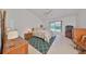 Spacious bedroom with tiled floor, ceiling fan, and a view of the backyard at 812 Mccallister Ave, Sun City Center, FL 33573
