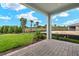 Covered patio with a view of the backyard and surrounding landscape at 20303 Symphony Pl, Venice, FL 34293