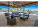 Covered patio with wicker furniture, ceiling fan, and lake view at 20303 Symphony Pl, Venice, FL 34293