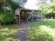 Covered patio area with grill, smoker and outdoor seating at 10311 Us Highway 98, Dade City, FL 33525