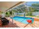 Relaxing screened-in pool and patio area with outdoor furniture at 4504 Horseshoe Pick Ln, Valrico, FL 33594