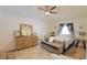 Bedroom with a bed, dresser, and ceiling fan at 4504 Horseshoe Pick Ln, Valrico, FL 33594
