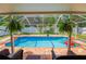 Inviting screened pool area with patio furniture and a basketball hoop at 4504 Horseshoe Pick Ln, Valrico, FL 33594
