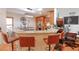 Kitchen island with seating and granite countertops at 4504 Horseshoe Pick Ln, Valrico, FL 33594