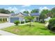 Single-story home with gray garage door and solar panels, landscaped yard at 4504 Horseshoe Pick Ln, Valrico, FL 33594