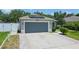 Front view of house with gray garage door and solar panels at 4504 Horseshoe Pick Ln, Valrico, FL 33594