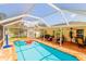 Large screened-in pool and patio with outdoor seating and a basketball hoop at 4504 Horseshoe Pick Ln, Valrico, FL 33594