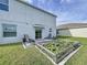 Spacious backyard with patio, garden, and grassy area at 17206 White Mangrove Dr, Wimauma, FL 33598
