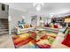 Spacious living room with off-white couches, colorful rug, and chandelier at 17206 White Mangrove Dr, Wimauma, FL 33598