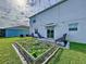 Backyard oasis featuring a patio and lush garden at 17206 White Mangrove Dr, Wimauma, FL 33598