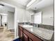 Modern bathroom vanity with granite countertop and single sink at 17206 White Mangrove Dr, Wimauma, FL 33598