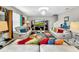 Bright living room features stylish couches, a large TV, and colorful rug at 17206 White Mangrove Dr, Wimauma, FL 33598