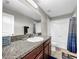 Clean bathroom with a shower/tub combo, granite countertop, and a single sink at 17206 White Mangrove Dr, Wimauma, FL 33598