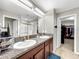 Double vanity bathroom with granite countertops and walk-in shower at 17206 White Mangrove Dr, Wimauma, FL 33598