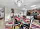 Modern dining area with glass table, black chairs, and kitchen view at 17206 White Mangrove Dr, Wimauma, FL 33598