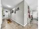 Elegant hallway with tile flooring, colorful rug, and wall art at 17206 White Mangrove Dr, Wimauma, FL 33598