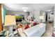 Living room with comfortable seating, large TV, and view into hallway at 17206 White Mangrove Dr, Wimauma, FL 33598