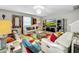 Spacious living area with comfortable seating and a large TV at 17206 White Mangrove Dr, Wimauma, FL 33598