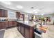 Kitchen with dark brown cabinets, granite countertops, and island at 17206 White Mangrove Dr, Wimauma, FL 33598