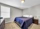 Comfortable bedroom with a king-size bed and nightstand at 17206 White Mangrove Dr, Wimauma, FL 33598