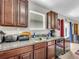 Kitchen with a double sink, granite counters, and dark wood cabinets at 17206 White Mangrove Dr, Wimauma, FL 33598