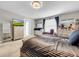 Bright bedroom with striped bedding and large windows at 17206 White Mangrove Dr, Wimauma, FL 33598