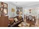 Spacious living room with leather couch, hardwood floors, and adjacent dining area at 2010 W Dekle Ave, Tampa, FL 33606