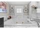 Luxurious bathroom with marble finishes, soaking tub, and walk-in shower at 2010 W Dekle Ave, Tampa, FL 33606