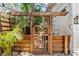 Wooden gate leading to a charming pathway at 2010 W Dekle Ave, Tampa, FL 33606