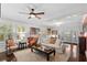 Open living room with hardwood floors, comfortable seating, and access to outdoor space at 2010 W Dekle Ave, Tampa, FL 33606