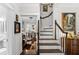 Elegant, winding staircase with dark wood floors and white railings at 2010 W Dekle Ave, Tampa, FL 33606