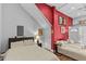 Bright bedroom with a comfy bed and red accent wall at 2010 W Dekle Ave, Tampa, FL 33606