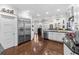Bright kitchen featuring stainless steel appliances and dark hardwood floors at 2010 W Dekle Ave, Tampa, FL 33606