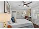 Charming bedroom with a brass bed frame, hardwood floors, and plantation shutters at 2010 W Dekle Ave, Tampa, FL 33606
