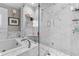 Elegant bathroom featuring a marble shower and soaking tub at 2010 W Dekle Ave, Tampa, FL 33606