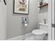 Stylish powder room with white toilet and wall-mounted shelving at 2010 W Dekle Ave, Tampa, FL 33606