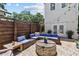 Relaxing patio with seating area, fire pit, and wood fence at 2010 W Dekle Ave, Tampa, FL 33606