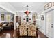 Charming dining room features a unique chandelier and hardwood floors at 2010 W Dekle Ave, Tampa, FL 33606