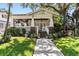 House exterior showcasing classic bungalow architecture and lush landscaping at 2010 W Dekle Ave, Tampa, FL 33606