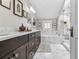 Elegant bathroom with marble flooring, soaking tub, and walk-in shower at 2010 W Dekle Ave, Tampa, FL 33606