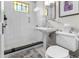 White subway tile bathroom with pedestal sink and glass shower at 2010 W Dekle Ave, Tampa, FL 33606