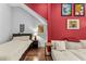 Cozy bedroom with a bed and red accent wall at 2010 W Dekle Ave, Tampa, FL 33606