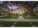 Charming bungalow with a large front porch, mature trees and well-maintained lawn at 2010 W Dekle Ave, Tampa, FL 33606