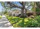 Home's exterior, showcasing its classic architecture and beautiful landscaping at 2010 W Dekle Ave, Tampa, FL 33606